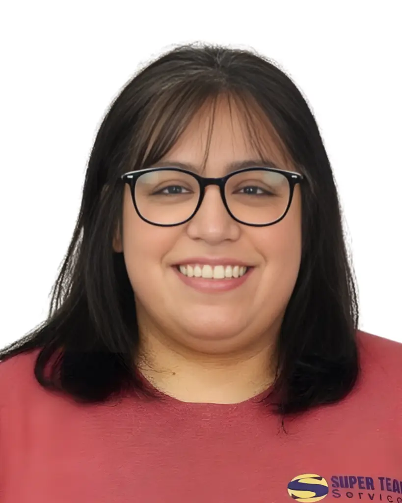A woman with straight, shoulder-length dark hair, wearing black glasses and a pink top, smiles at the camera. Part of a logo with the words SUPER TE is visible on her shirt.